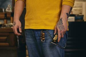 Stylish barber man with hairdressing tools in his hands prepare for work photo