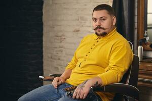 Stylish barber man with hairdressing tools in his hands prepare for work photo