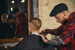 Caucasian boy getting haircut in barbershop indoor photo