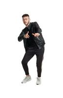 Full-length photo of a funny guy dancing in studio isolated on white background.