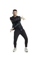 Full-length photo of a funny guy dancing in studio isolated on white background.
