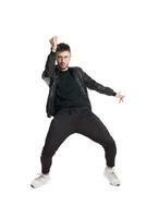 Full-length photo of a funny guy dancing in studio isolated on white background.