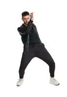 Full-length photo of a funny guy dancing in studio isolated on white background.