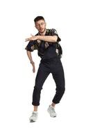 Full-length portrait of a funny guy dancing in studio isolated on white background. photo