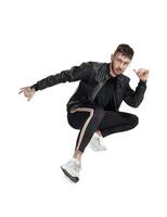 Full-length photo of a funny guy dancing in studio isolated on white background.