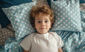 ai generado un pequeño chico tendido en cama con azul y blanco almohadas alrededor su cabeza foto