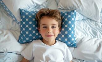 AI generated a little boy laying in bed with blue and white pillows around his head photo