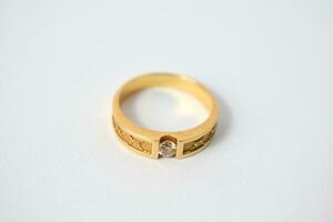 Close Up Golden ring with diamond on isolated white background photo