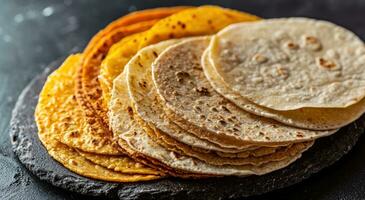AI generated a range of different types of Mexican tortillas on a table on black background photo