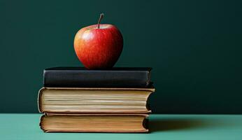 ai generado manzana en un apilar de libros educación foto