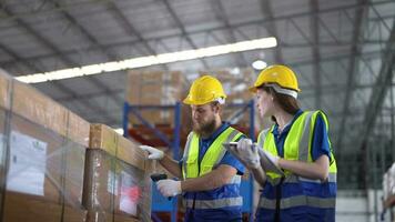 operation workers checking and inspecting cargo for stack items for shipping. Supervisor and staff working in factory warehouse discuss about parts inventory. Worker Scanning Package In Warehouse. video