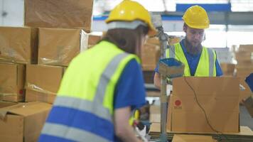 Warehouse worker folding paper box for packing the items in a large warehouse. man sealing cardboard boxes for shipping in cargo product stock. video