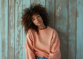 AI generated young woman wearing a peach sweatshirt and jeans with curly brown hair, photo