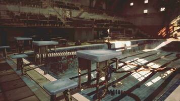 An abandoned swimming pool with empty benches and tables video