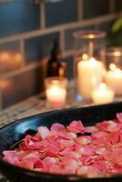 AI generated Rose-petal-filled Tub, Candles, and Aromatic Essential Oils photo