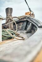 Bow of old wooden boat photo