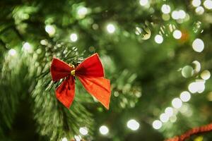 Close-Up of Christmas Tree with Ornaments and Garland with Lights photo