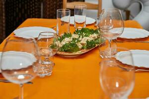 Elegant Table Setting with Glasses, Plates, and Delicacies for New Year's Celebration photo