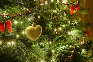 Close-Up of Christmas Tree with Ornaments and Garland with Lights photo