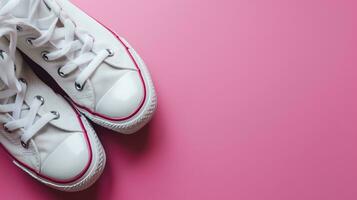 ai generado blanco lona Zapatos en un rosado antecedentes foto