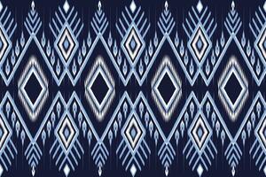 Ethnic Blue and White Ikat Pattern on Dark Blue background.  Seamless Pattern Vector design for fabric, tile, carpet, embroidery, wallpaper and background
