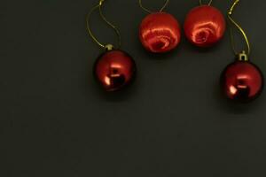 Christmas background with red baubles on black background photo