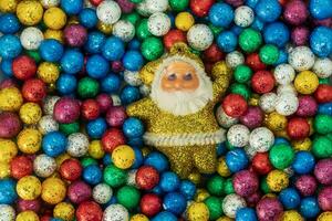 Santa Claus and colorful Christmas balls background. photo