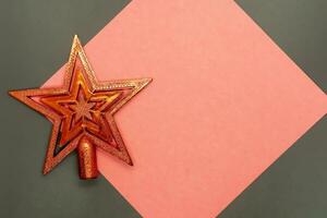 Christmas star decoration on a red and gray background with copy space. photo