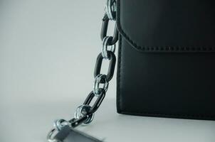 Bag strap on metal carabiner and chain photo