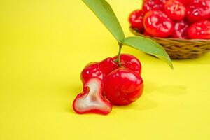 fresh water apple fruit and some water apple on basket behind on yellow background photo