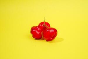 fresh water apple fruit and some water apple on basket behind on yellow background photo