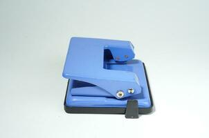 blue paper hole puncher on the white background photo