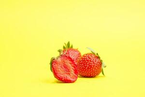 Group of strawberry isolated on yellow background photo