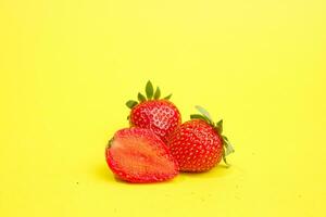 Group of strawberry isolated on yellow background photo