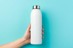 AI generated Hand Presenting Reusable White Water Bottle on Turquoise Background photo