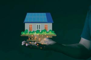 A engineering hand holding solar cell house photo