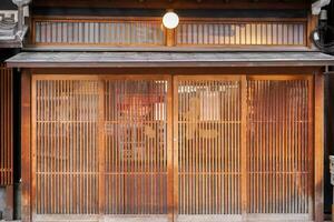 Closeup ancient wooden doors of small Japanese restaurant. photo