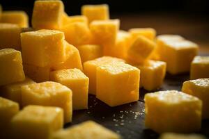 AI generated Close-up of a plate of yellow cheese cubes. photo