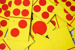 dominoes playing cards isolated white background, yellow red dominoes cards photo