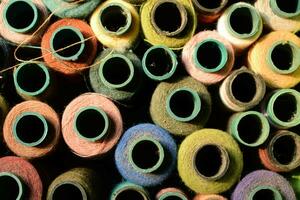 Close up old vintage thread coils multicolored photo