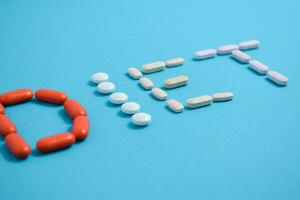 Diet word from Colorful Medicine Pills isolated on blue background, supplement, vitamin, colorful photo