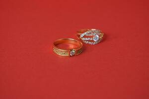 Close Up Golden ring with diamond on isolated red background photo