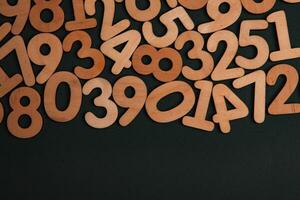 Colorful wooden numbers on a blackboard background with space for text photo