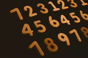 Colorful wooden numbers on a blackboard background with space for text photo
