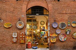 Beautiful colored and medieval street in the old town of Siena, Italy photo