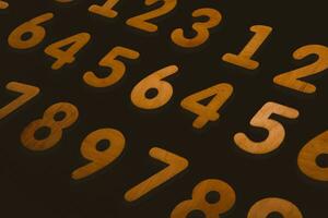 Wooden numbers on a black background. Numbers of different colors. photo