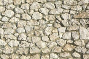 Background of stone wall texture photo. Close-up of stone wall. photo