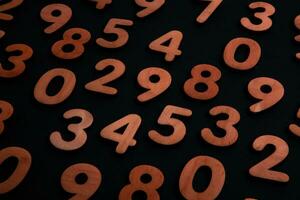 Numbers on a dark background. Seamless pattern. Toned. photo