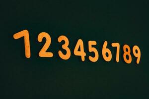 Colorful wooden numbers on black background. Number 1 to 9. photo