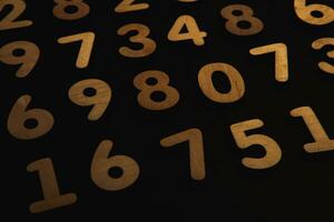 Colorful wooden numbers on a blackboard background with space for text photo